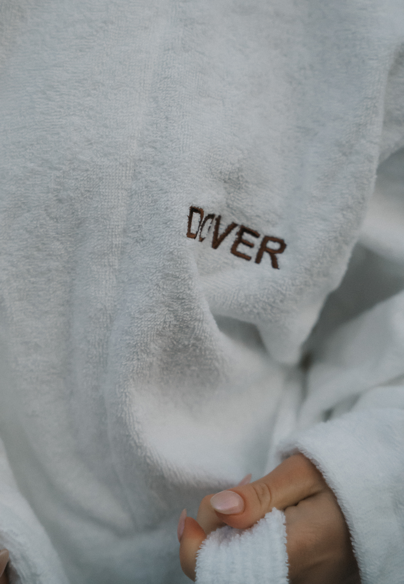 Close-up of DOVER embroidered on a plush robe