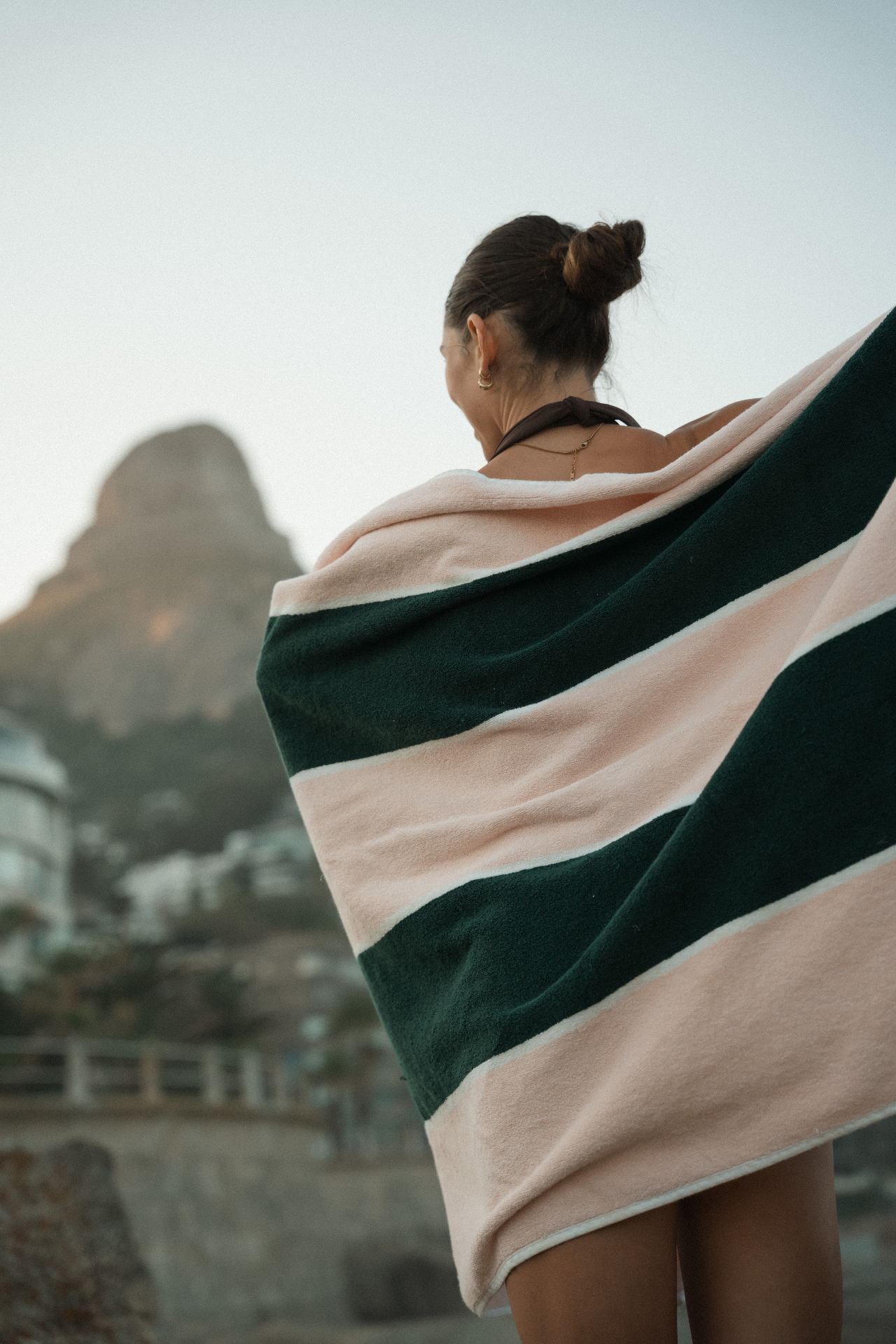 Dover pool towel draped over shoulders overlooking the coast
