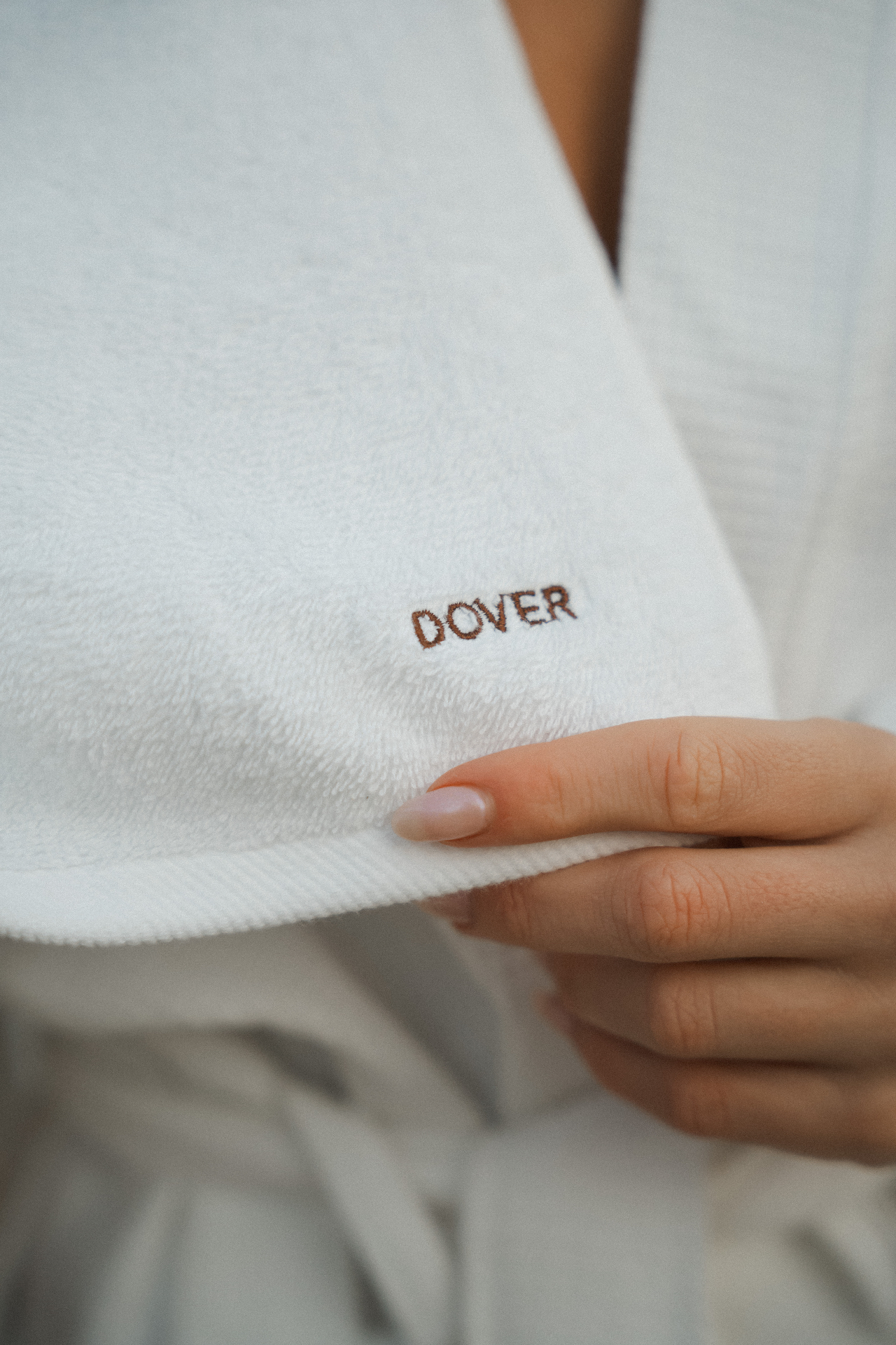 Hand holding the edge of a Dover towel